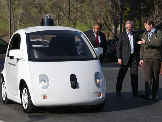 Google car project lead Chris Urmson, far right, shows
