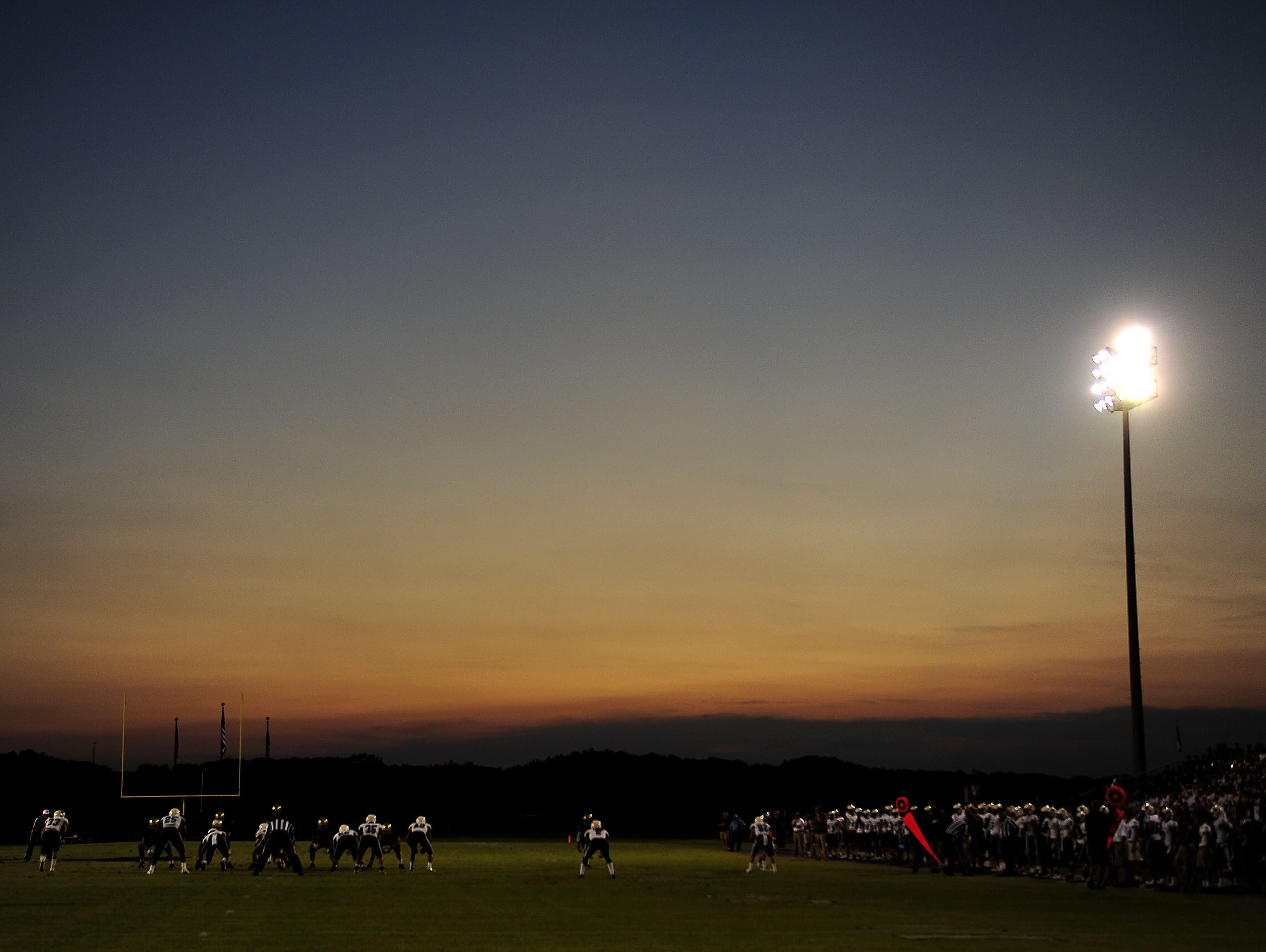 The sun sets in the background during the Centennial and Independence game at Independence High School in Thompson's Station, Tenn., Friday, Aug. 28, 2015.