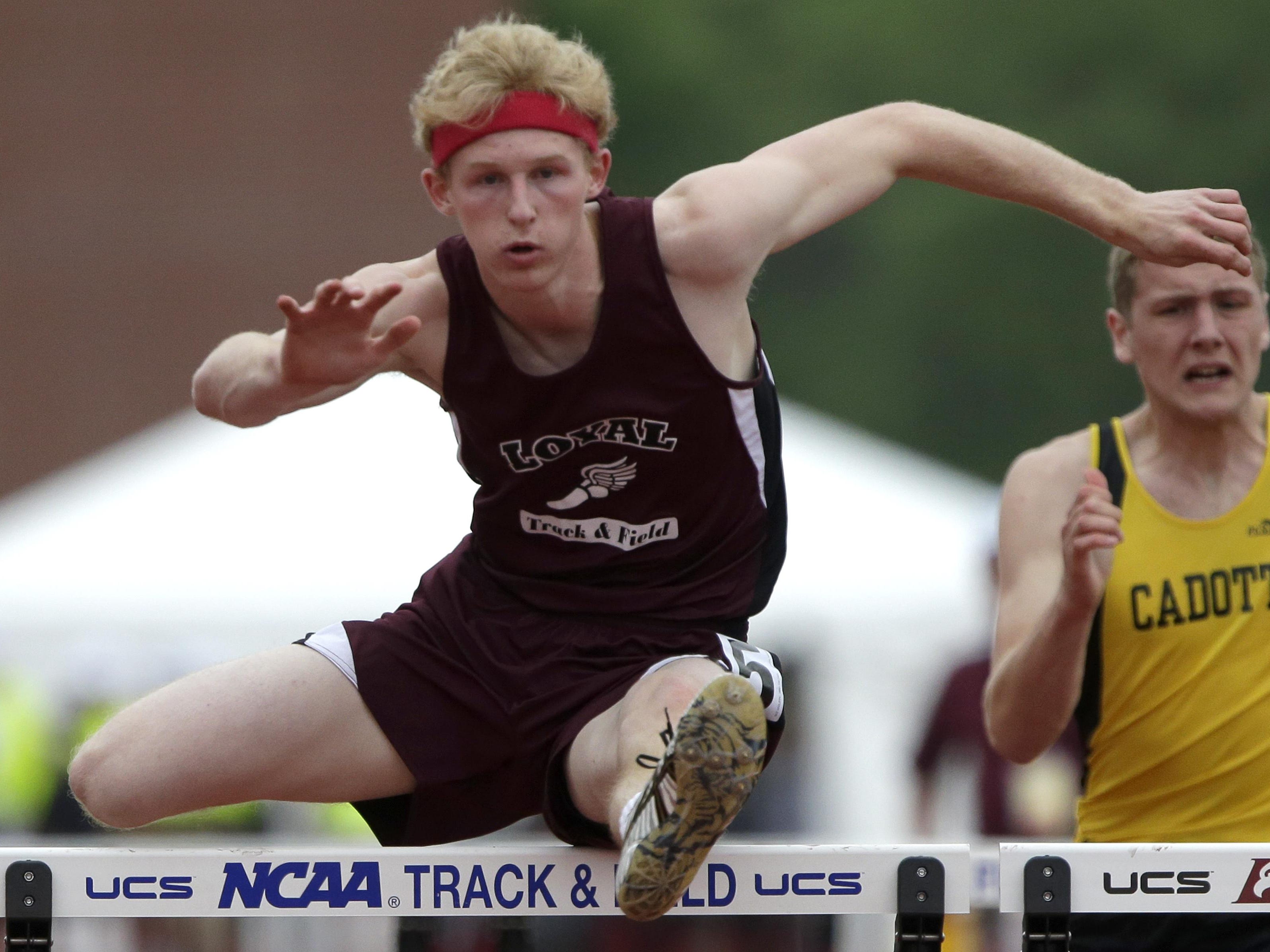 Loyal senior Malm glides over a hurdle during the Division 3 110 hurdles during the WIAA state track meet Satruday. Malm won the 110s and 300s.