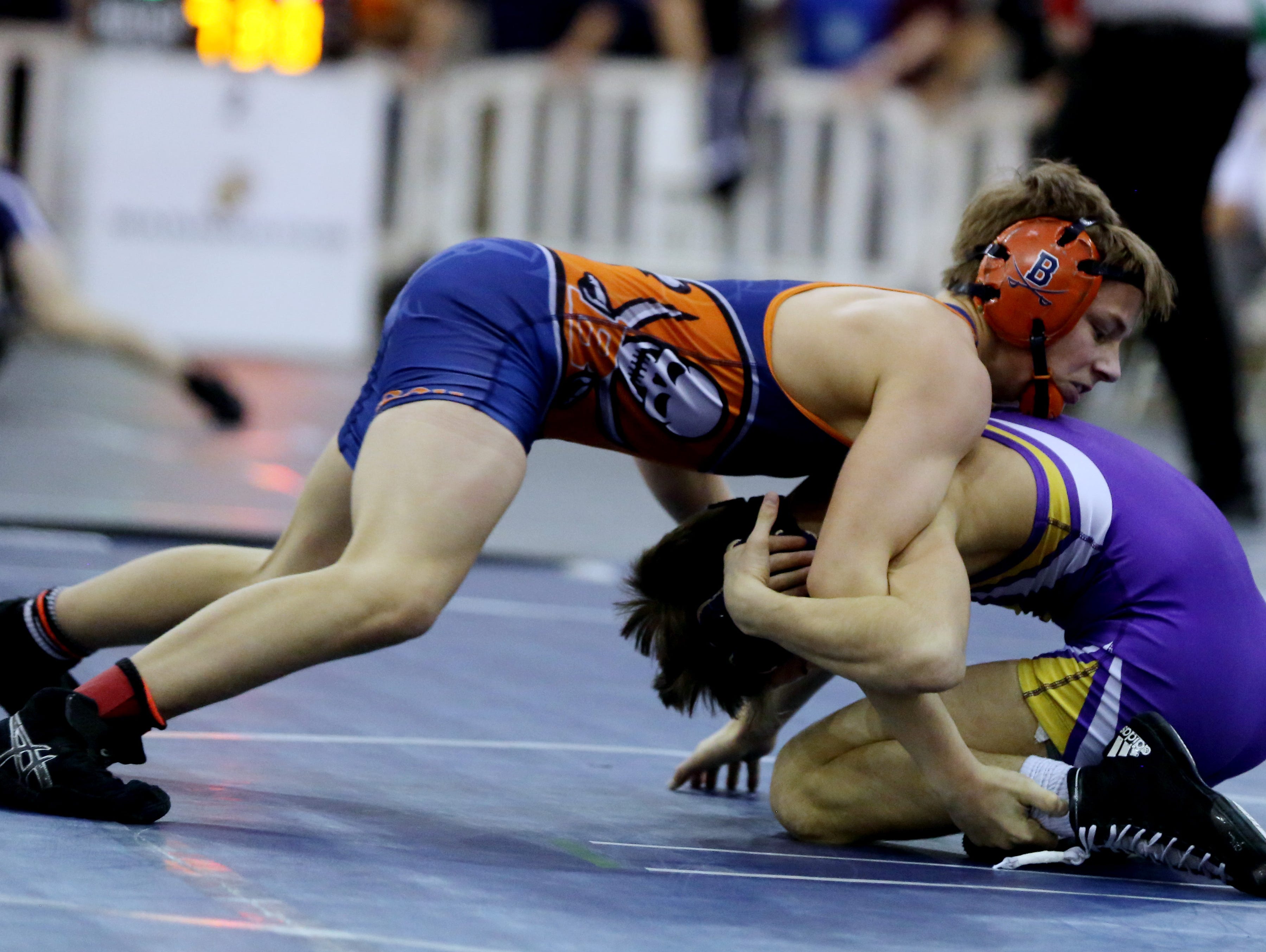 Beech High School's Brayden Palmer, left in blue and orange, competes with Lawrence County's Luke Dezember in the 106-pound semifinals at the TSSAA State Wrestling Tournament Friday.