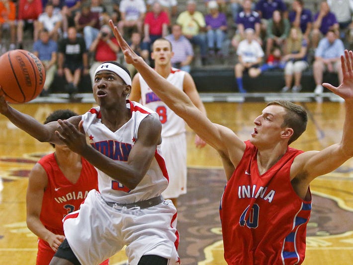From left, Eugene German (3), of Gary 21st Century, takes a shot despite defense from junior Jack Nunge (40), of Castle, during the Indiana boys junior All-Stars versus senior All-Stars, at Bloomington South, June 7, 2016.
