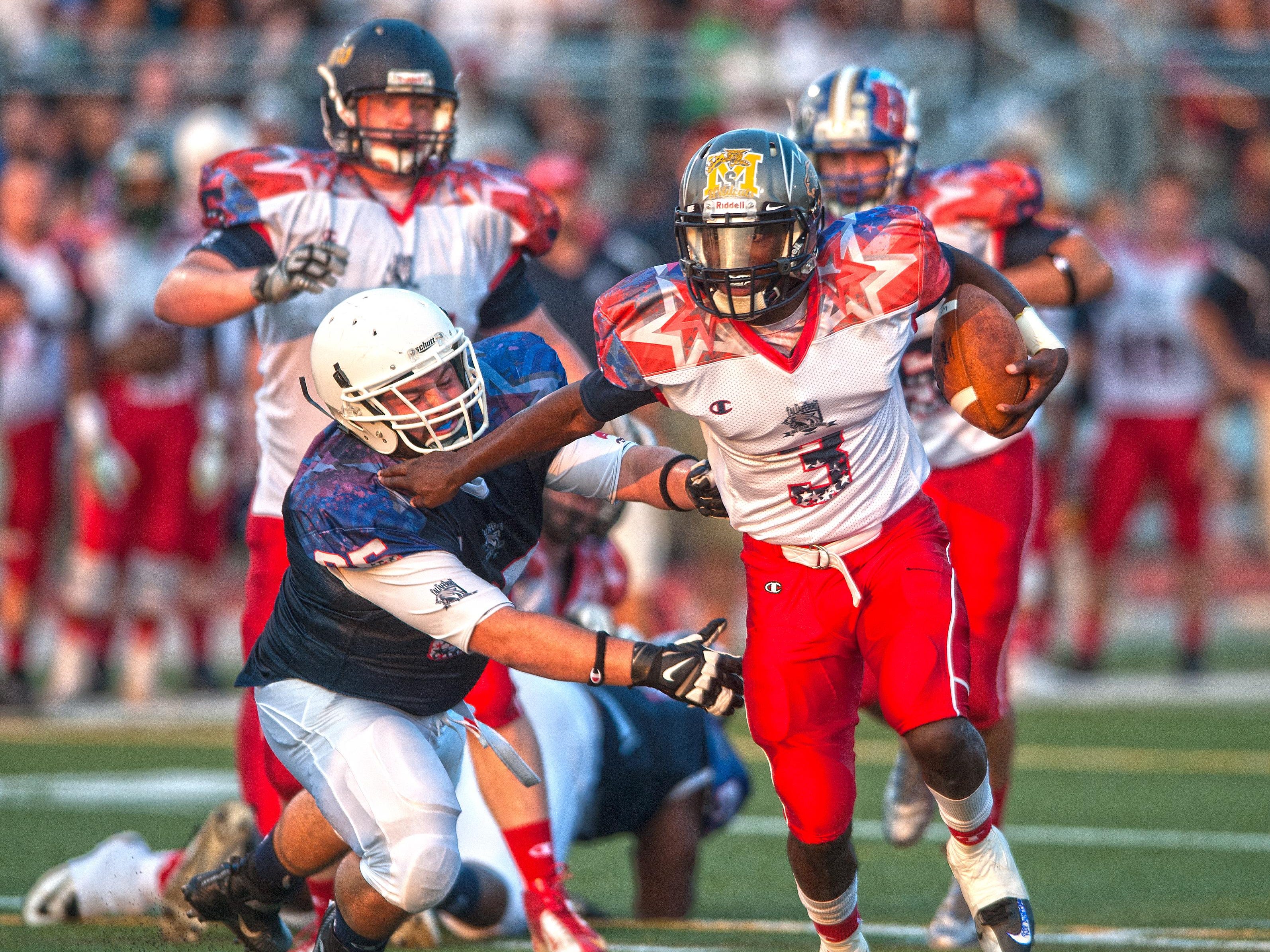 White Squad quarterback Khalil Trotman breaks away from Blue Squad Joe Greco during the second quarter of the South Jersey Coaches-Adam Taliaferro All-Star Football Classic.