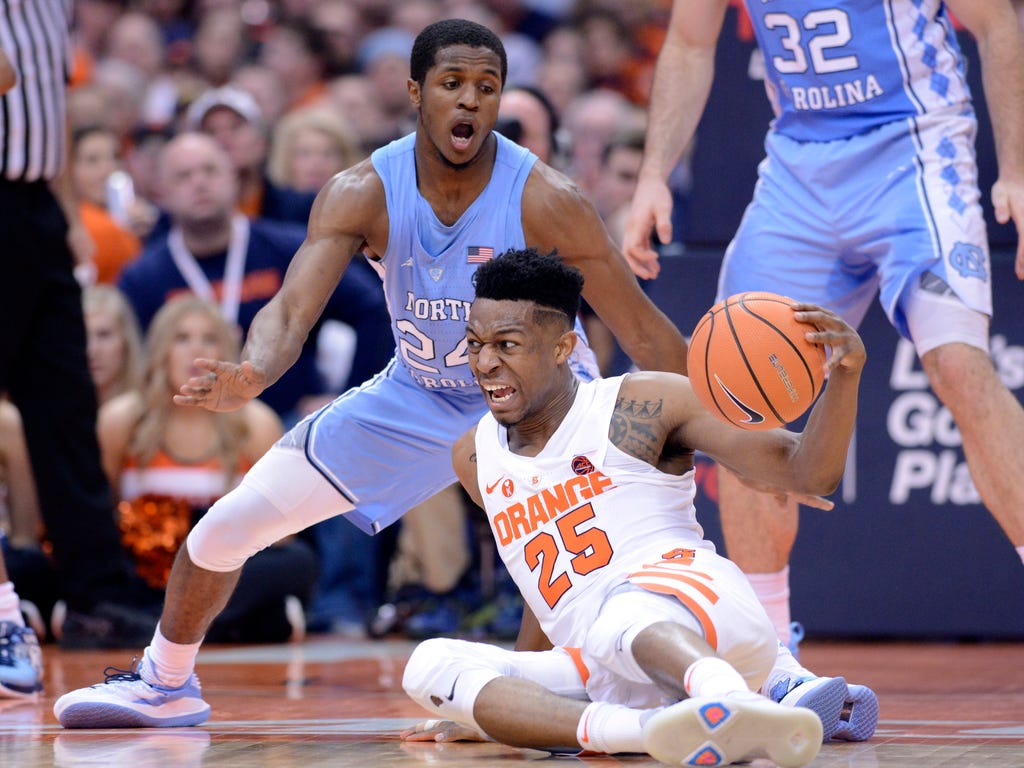 Syracuse Orange guard Tyus Battle slips to the floor while dribbling as North Carolina Tar Heels guard Kenny Williams defends in the first half at the Carrier Dome in Syracuse, N.Y.