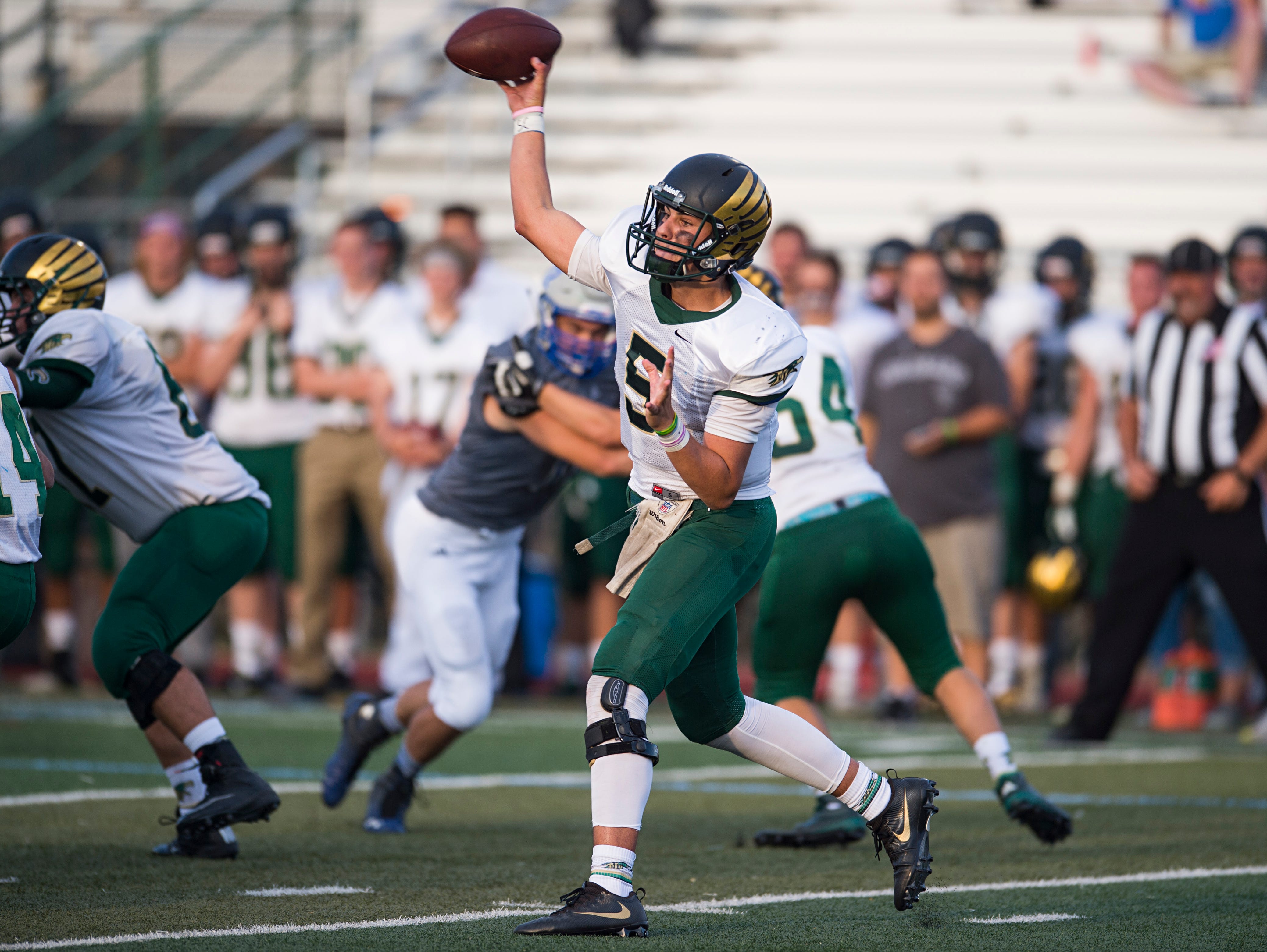 Mountain Vista quarterback Judd Erickson sends the ball to a receiver during a game against Poudre at French Field Thursday, September. The Golden Eagles quarterback stopped the Impalas with 450 yards and a 67-37 victory.