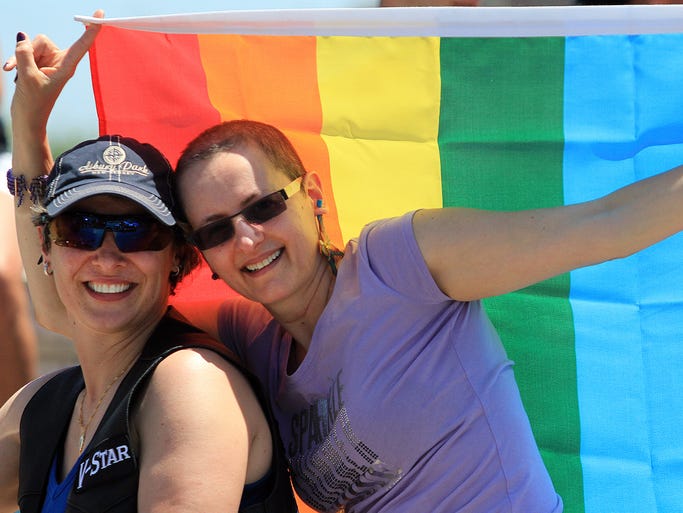 ASB 0602 GAY PRIDE Isabelle Ferreira, of Asbury Park, left, and partner Fabiula Silva, who were married in Nov. 2013, show their pride during the Jersey Pride parade and festival in Asbury Park, Sunday, June 1, 2014. Asbury Park, NJ - Photo by Mary Frank