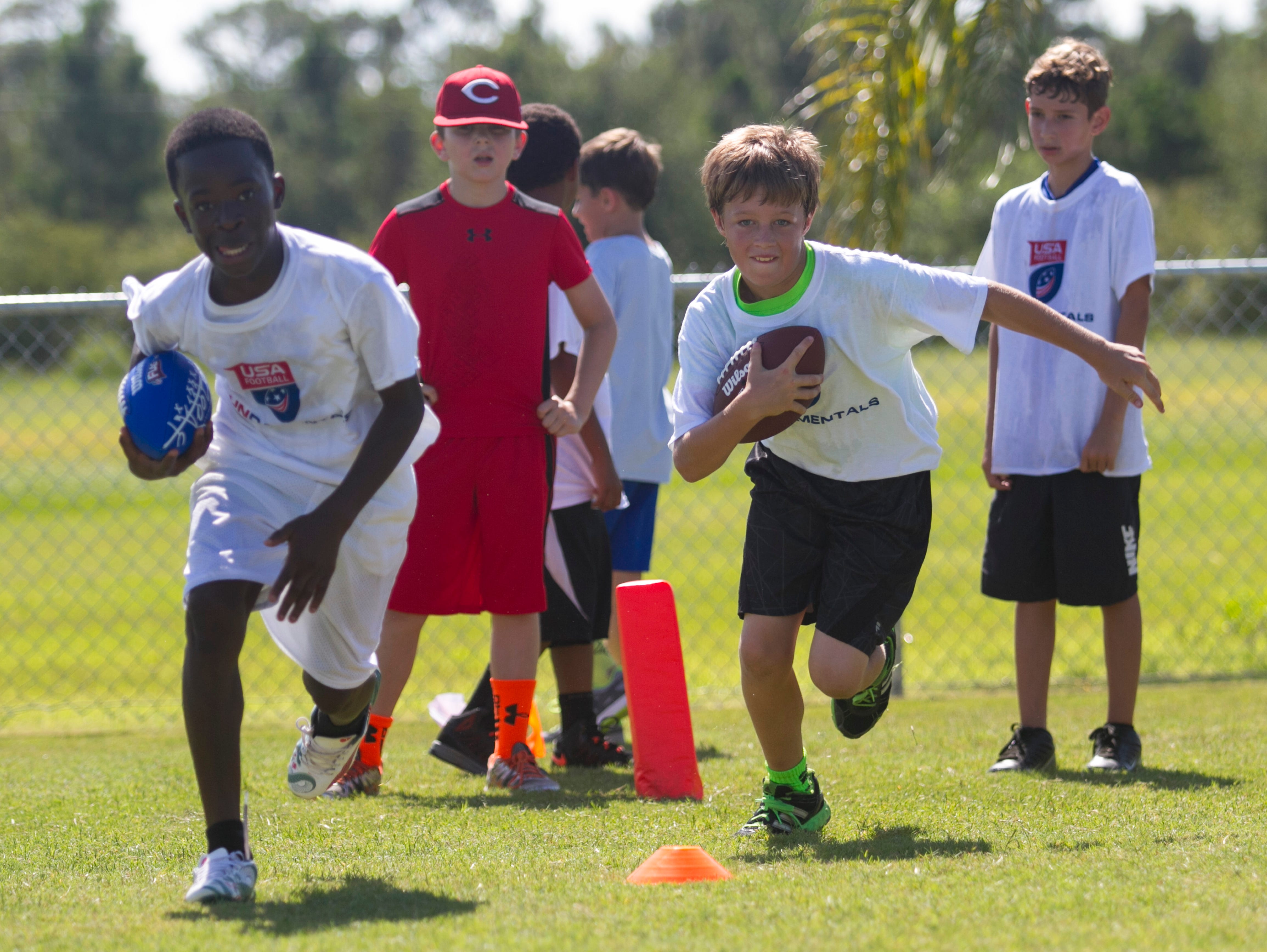 A group runs drills at a free youth football camp at McGregor Baptist Church run by Nate Allen of the Oakland Raiders on Saturday.