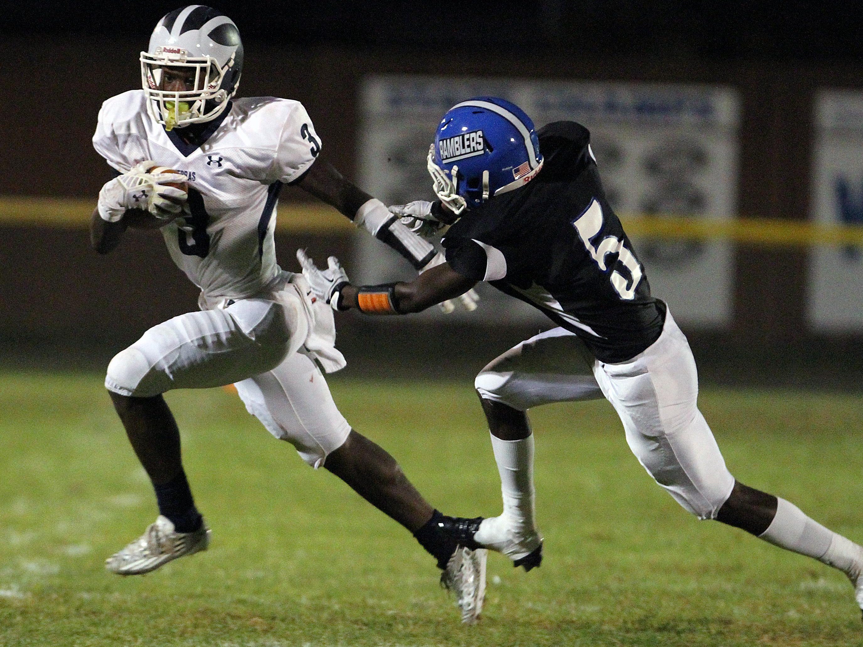 The New Brunswick High School Zebras traveled up the Turnpike to take on the Ramblers of Carteret High School in a varsity football game.New Brunswick's # 3 (left)- Maurice Ffrench gets around the tackle attempt of Carteret's # 5 (right)- Hassan Williams.On Friday September 26,,2014Photo: Mark R. Sullivan/Staff Photographer