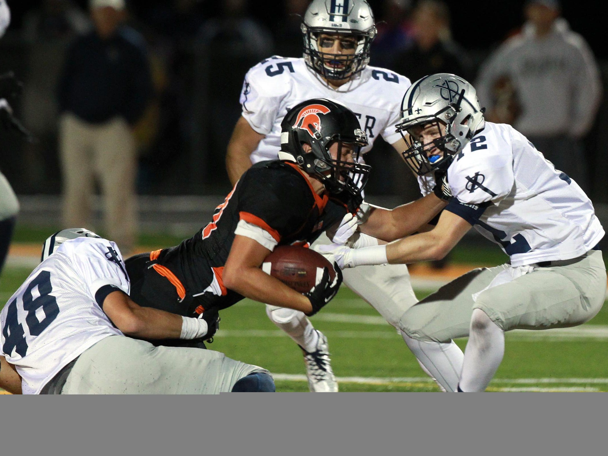 Solon's Bo Black converts a third down during the Spartans' game against Cedar Rapids Xavier at Solon on Friday.