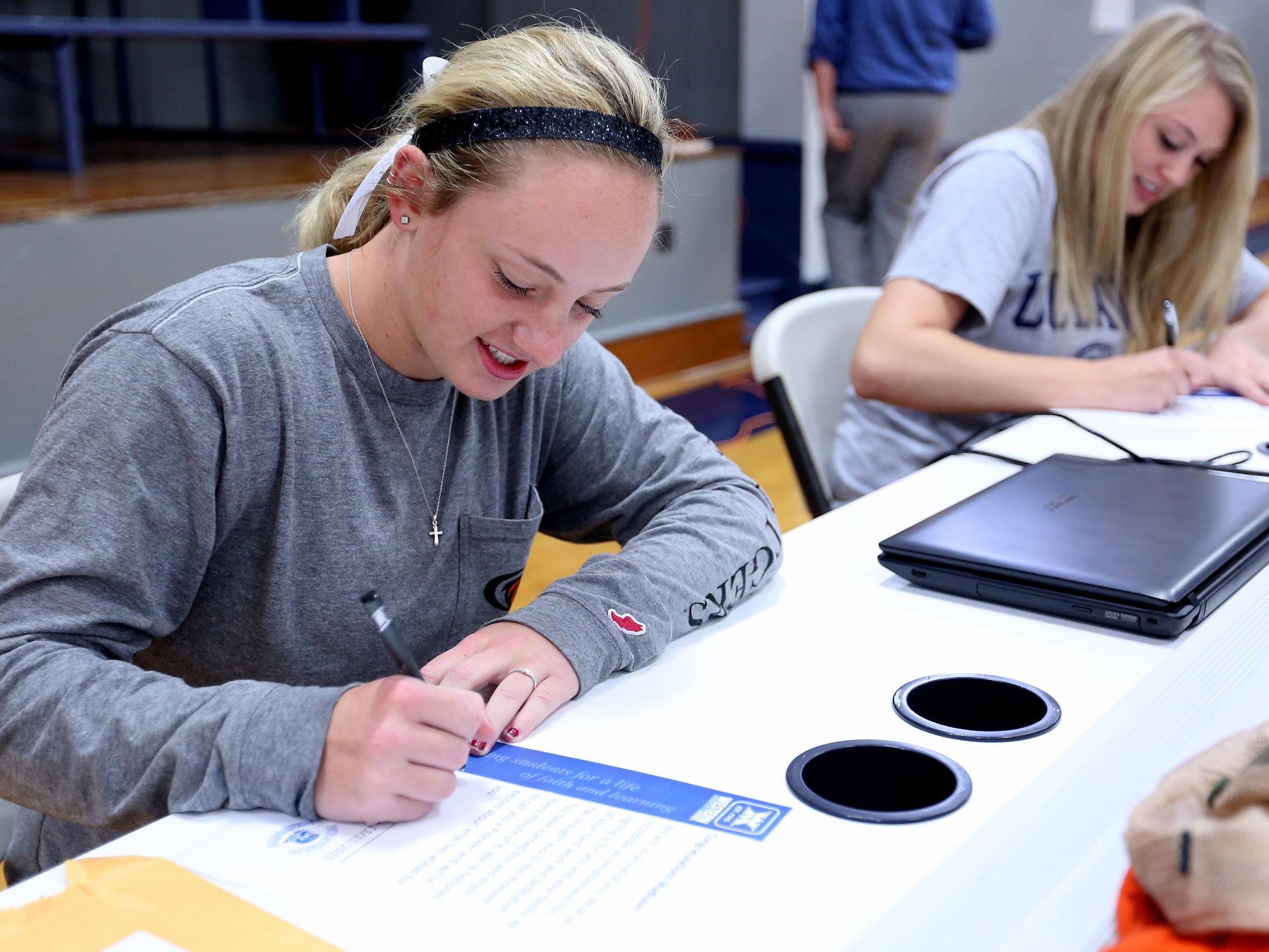 Maddie Hopper, left, signs a letter of intent to play softball with the University of the Pacific while Emma Gibb signs a letter of intent to play basketball at UC Davis at Western Mennonite High School in Salem on Wednesday, Nov. 11, 2015.