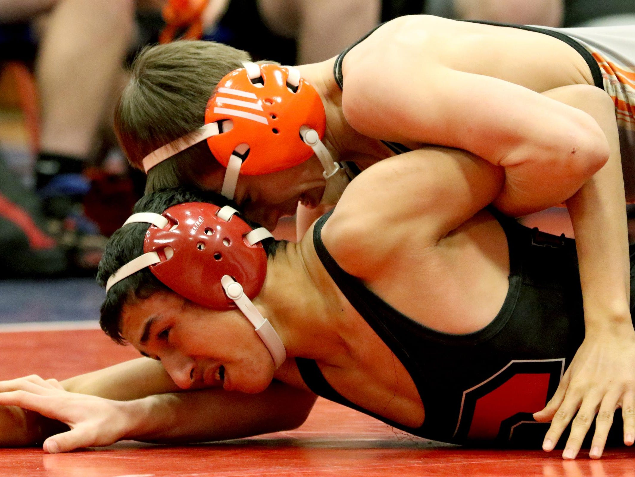 Dallas' Joseph Foster, top, and Central's Manuel Martinez compete in the 120 pound weight class during a wrestling meet at Lebanon High School in Lebanon, Ore., on Wednesday, Jan. 6, 2015.