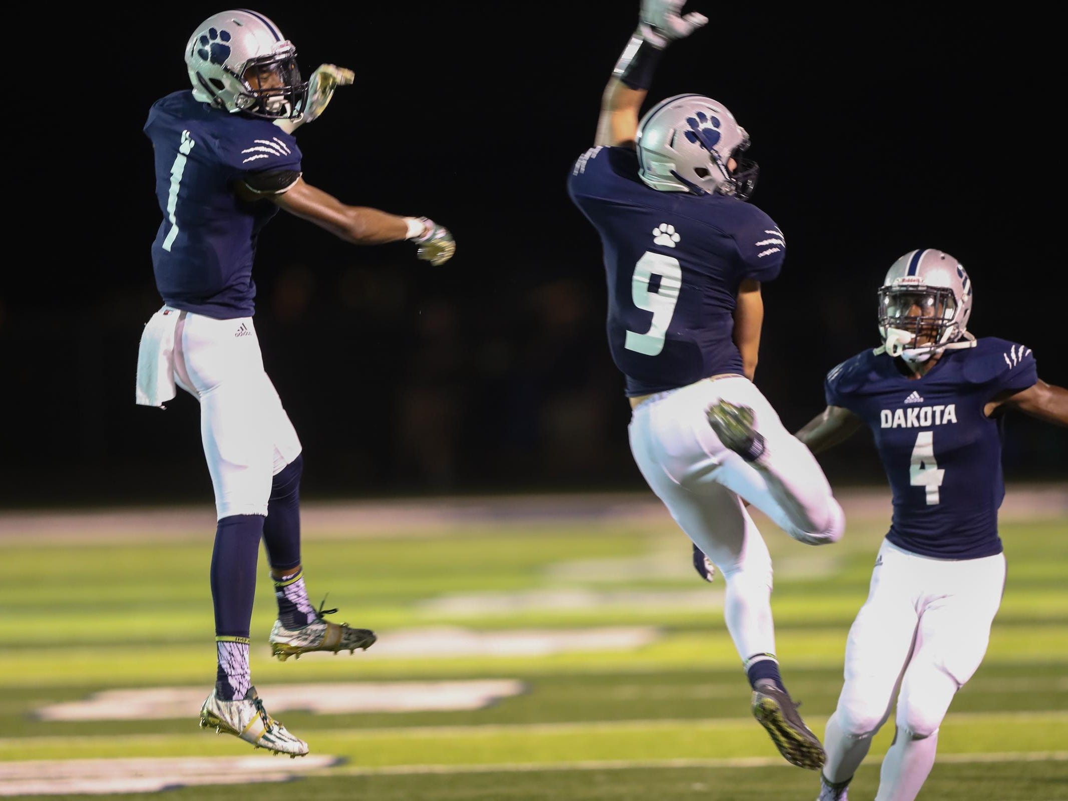 Macomb Dakota players celebrate a fumble recovery during the second half of the 35-28 win over Orchard Lake St. Mary’s on Thursday at Dakota.