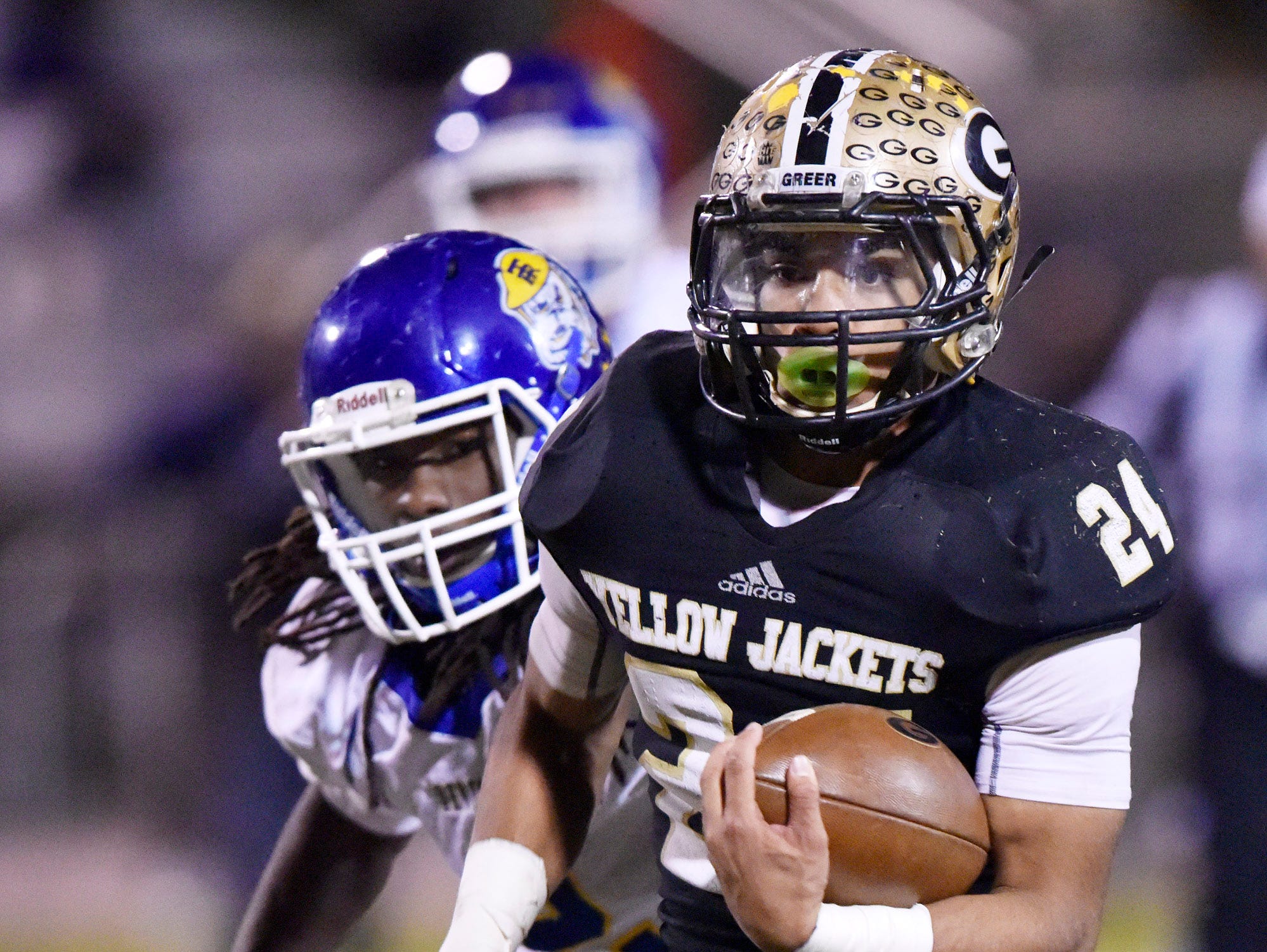 Greer's Adrian McGee (24) leaves Travelers Rest's defense on a touchdown run.