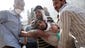 Supporters of Mohammed Morsi carry a wounded protester.