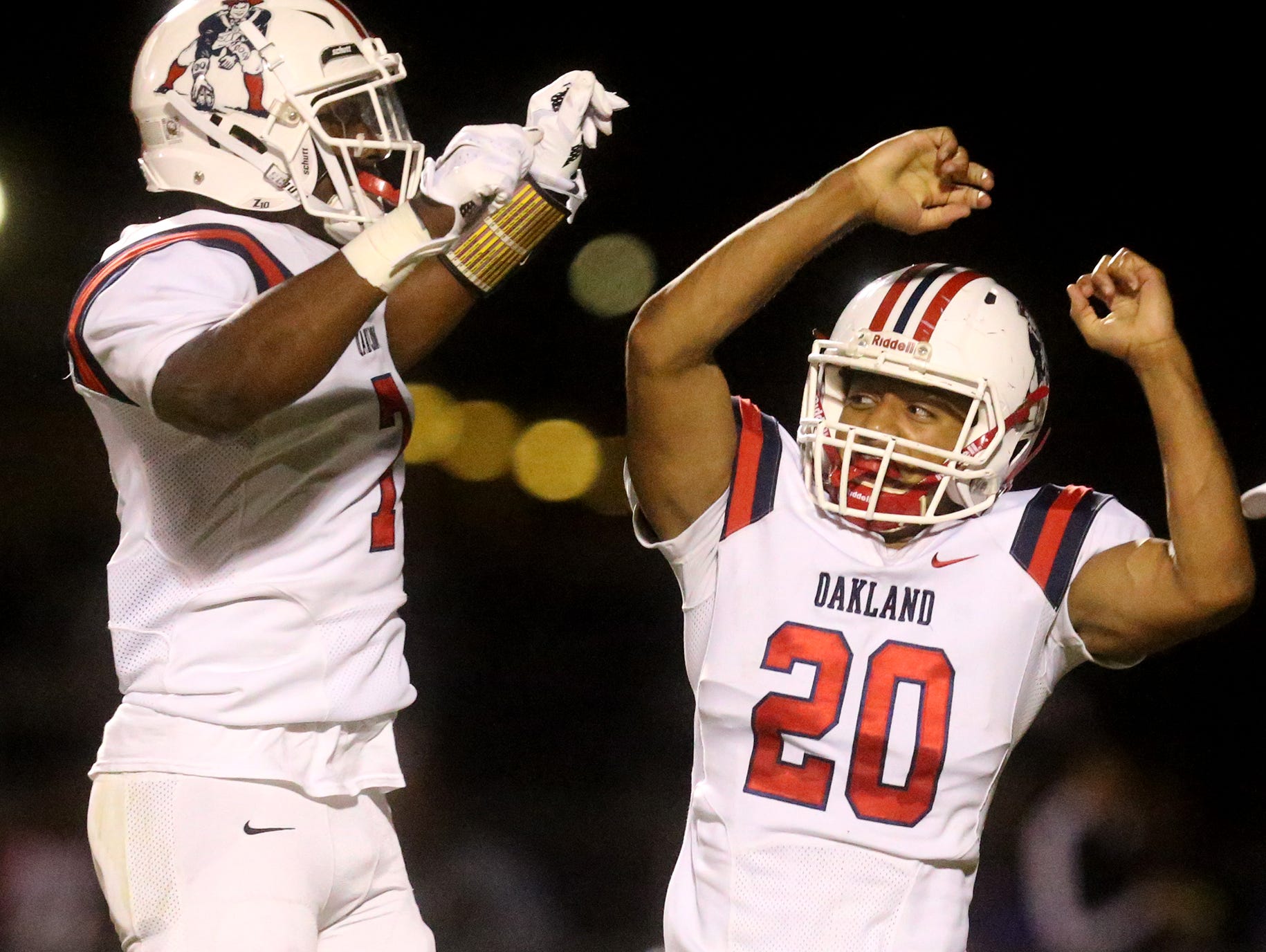 Oakland's Brandon Turner (20) and Jacoby Stevens (7) celebrate Turner's fumble recovery during the game against Riverdale on Friday, Oct. 14, 2016, at Riverdale.