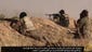 Islamic State militants battle advancing Iraqi troops at an undisclosed location near the border with Syria on June 17.