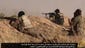 Islamic State militants battle advancing Iraqi troops at an undisclosed location near the border with Syria on June 17.