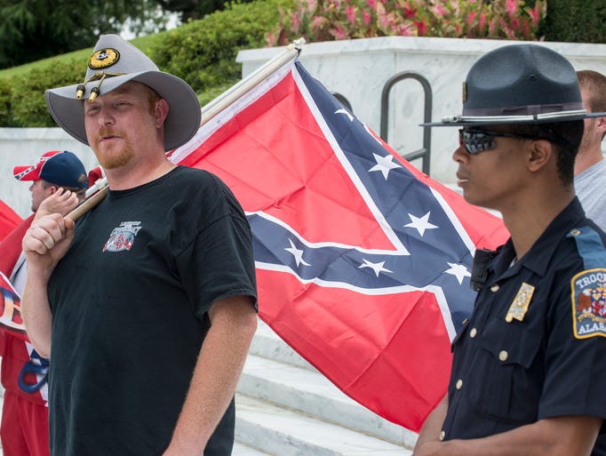 Jeremy Boothe of Tuscaloosa holds a Confederate battle