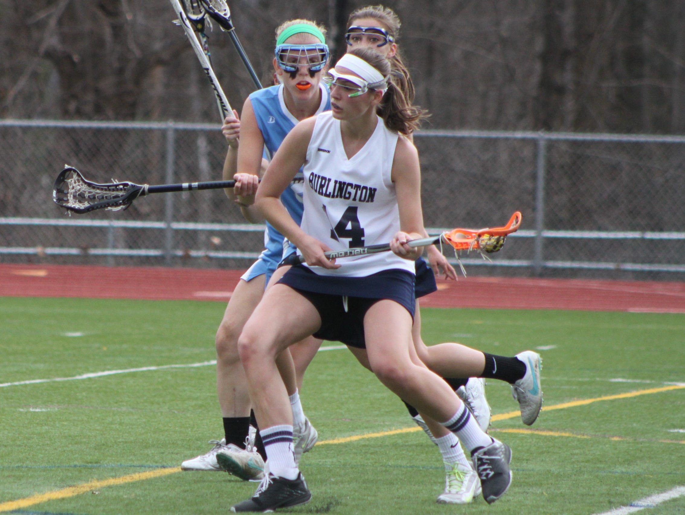 Burlington's Casey O'Neill protects the ball against South Burlington's Sarah Fisher during a girls lacrosse game on Thursday.