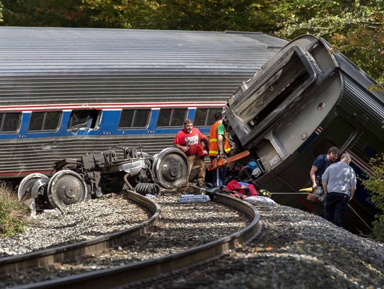 work at the scene of an Amtrak passenger train derailment near 
