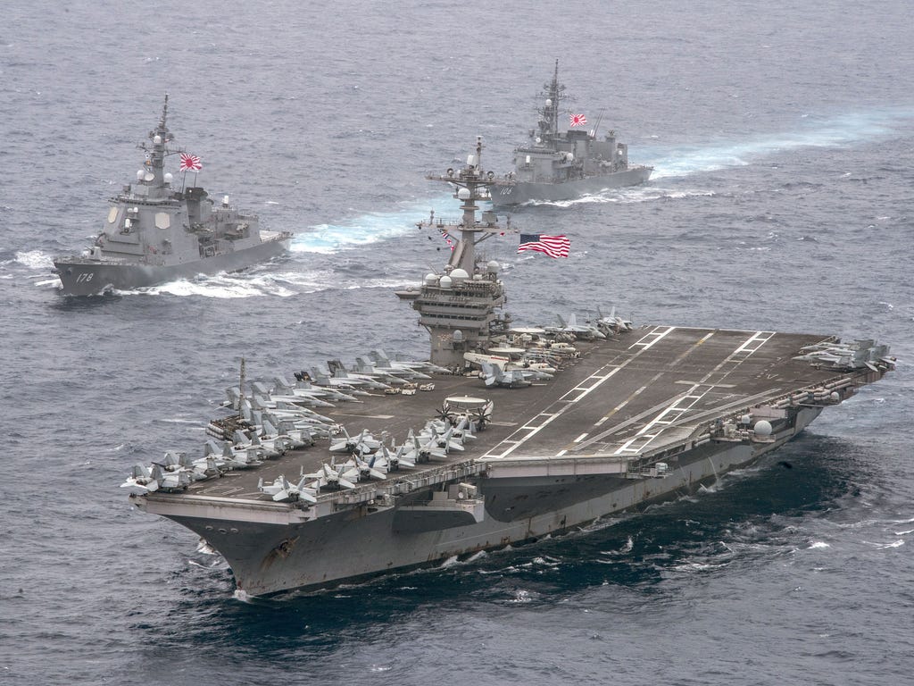 The aircraft carrier USS Carl Vinson (CVN 70), foreground, transits the Philippine Sea with the Japan Maritime Self-Defense Force (JMSDF) Atago-class guided-missile destroyer JS Ashigara (DDG 178), left front, and the JMSDF Murasame-class destroyer J