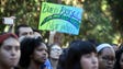A student demonstrator holds a sign as she is joined