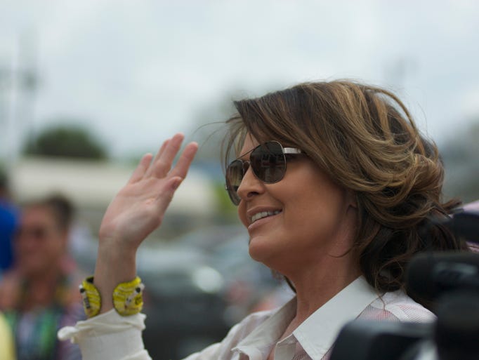 Sarah Palin waves to admirers Sunday at the 88th Annual