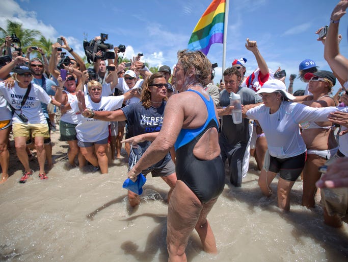 Swimmer Diana Nyad, 64, is greeted by a crowd as she walks on to the Key West, Fla., shore, becoming the first person to swim from Cuba to Florida without the help of a shark cage.