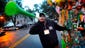 Street vendor Marshall Baker blows a horn to attract customers before the start of a St. Patrick's Day parade in Savannah, Ga.