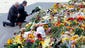 Kees Klompenhouwer, the Dutch ambassador to Ukraine, left, and Ukrainian President Petro Poroshenko lay flowers to commemorate the victims of the crash at the Dutch Embassy in Kiev.