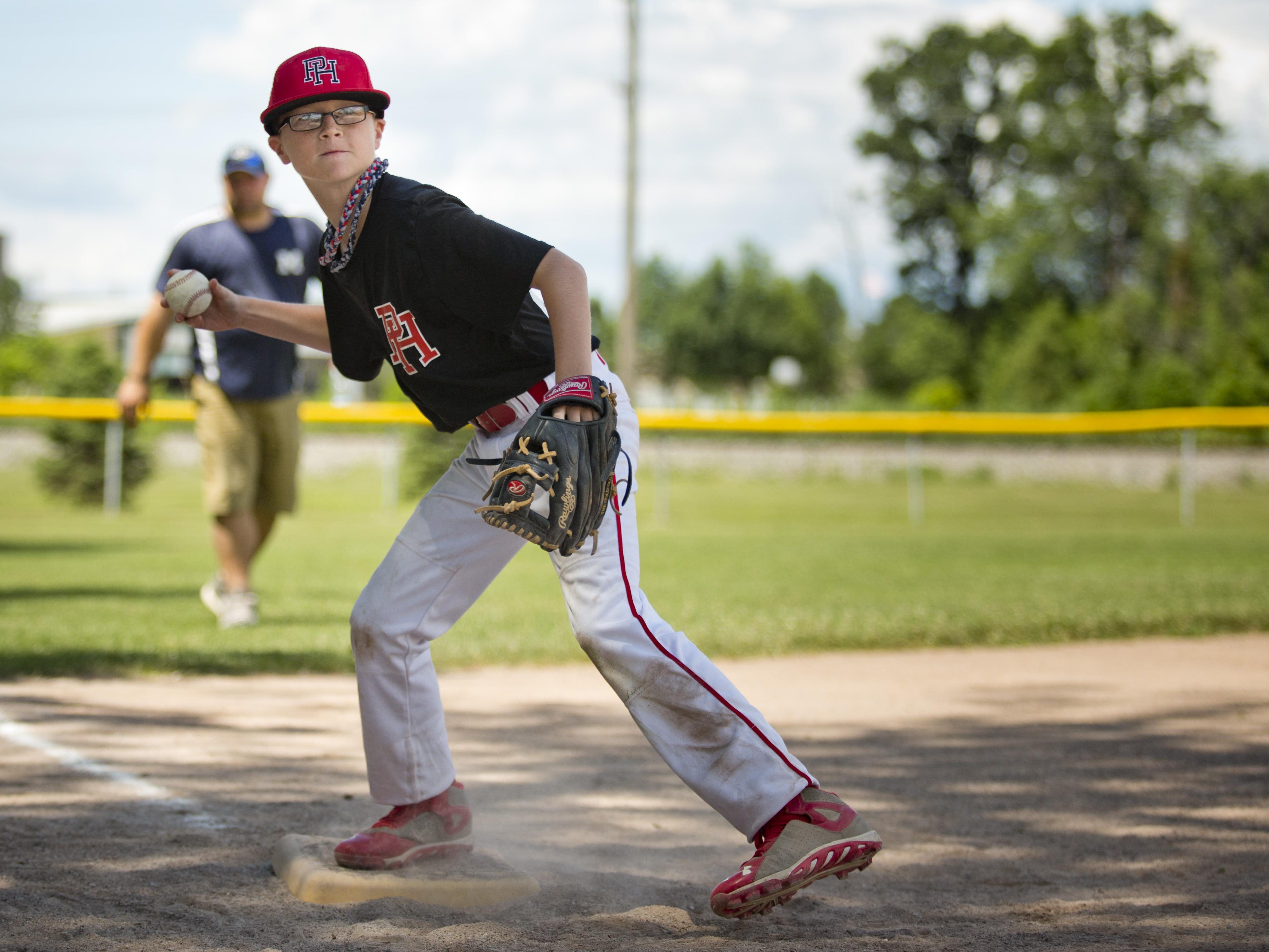 Brayden Albers, 10, throws the ball to home while competing in throwing with his Port Huron teammates during a Little League skills competition Saturday, August 1, 2015 at Marysville City Park.