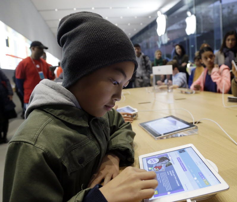 Tyson Navarro, 10, of Fremont, Calif., learns to build code using an iPad at a youth workshop at the Apple store in 2013. Apple stores were participating in computer science education week, part of a joint effort with Code.org to teach children the b