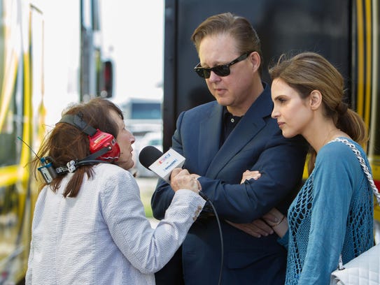 Brian France, center, and wife Amy, right, are interviewed