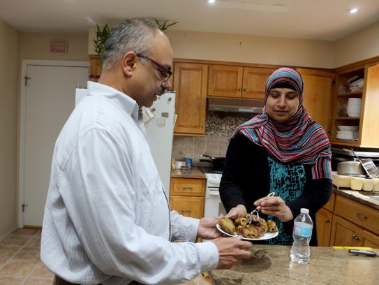 Afzfar Faroq and helps his wife Saba prepare dinner