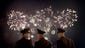 North Korean soldiers watch as fireworks explode, Monday,