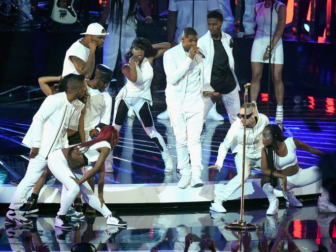 Usher (C) performs onstage during the 2014 MTV Video Music Awards at The Forum on August 24, 2014 in Inglewood, California.