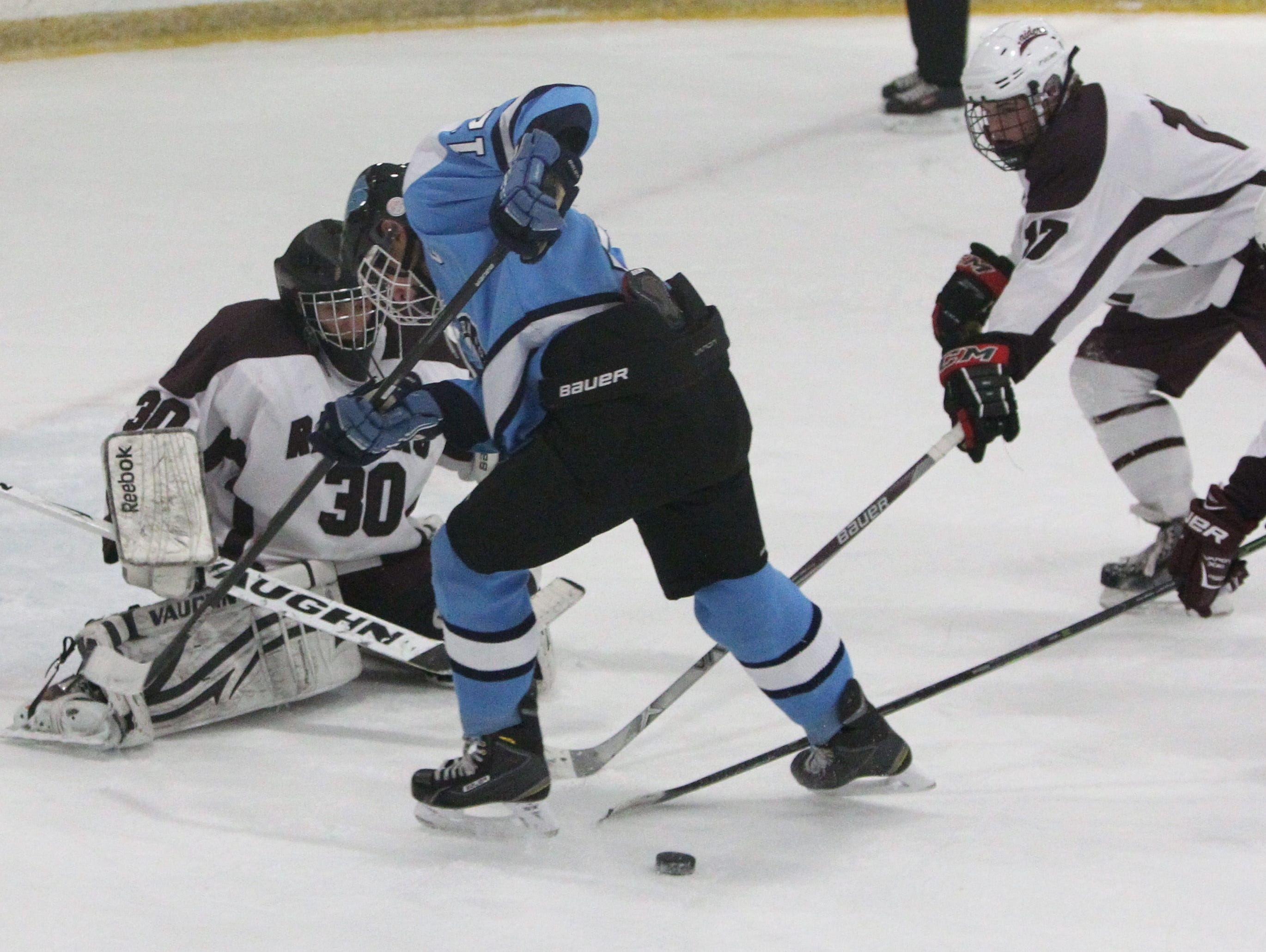 Suffern's Mike Ruthberg is stopped by Scarsdale goalie Sam Seltzer, Stephen Nicholas and Charles Gliatta during their game at the E.J. Murray rink in Yonkers Dec. 7, 2015. Scarsdale won 1-0.