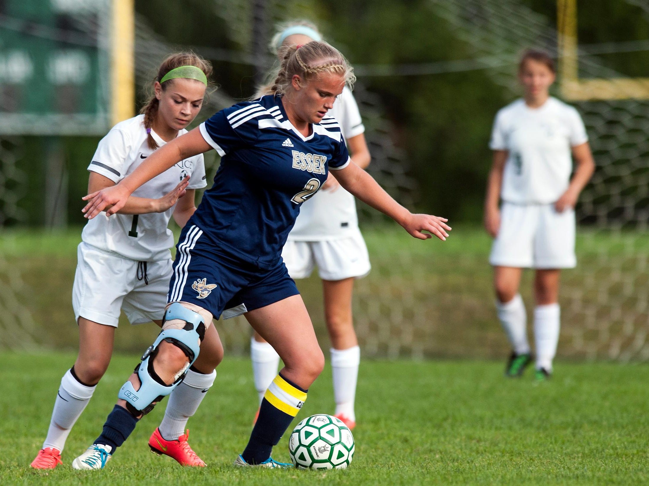 Essex's Megan Macfarlane (20) controls the ball during the girls soccer game between the Essex Hornets and the Rice Green Knights at Rice High School on Wednesday afternoon in 2014.