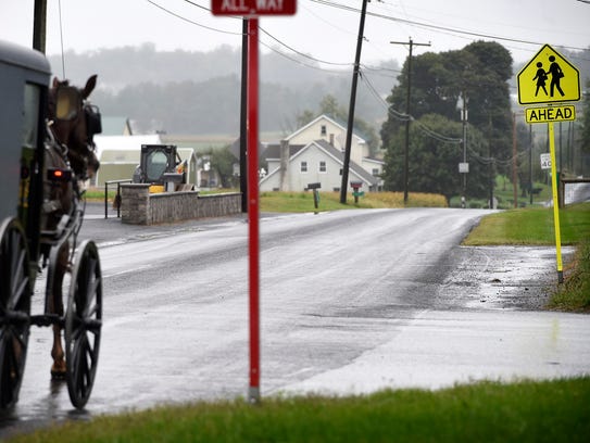 Amish buggies pass by the New Hope Amish School Wednesday,