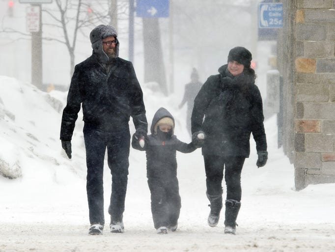Snow blows through Erie, Pa., as 3-year-old Louis Rullo