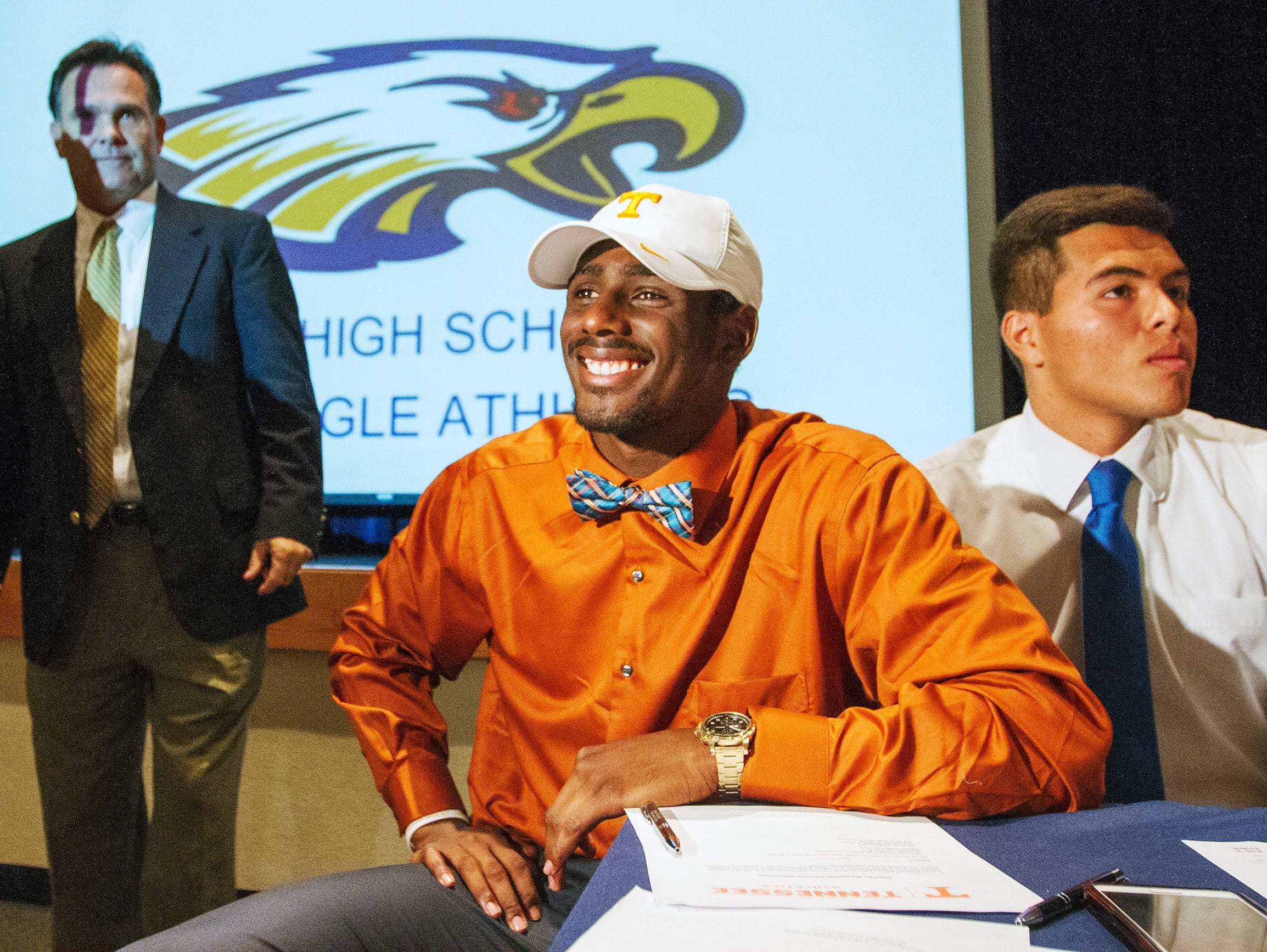 Naples High School football players Tyler Byrd, center, and Jerry Nunez, right, were among the school's athletes who signed National Letters of Intent Wednesday at the school. Byrd is going to the University of Tennessee and Nunez to Indiana State University. Head coach Bill Kramer is at left.