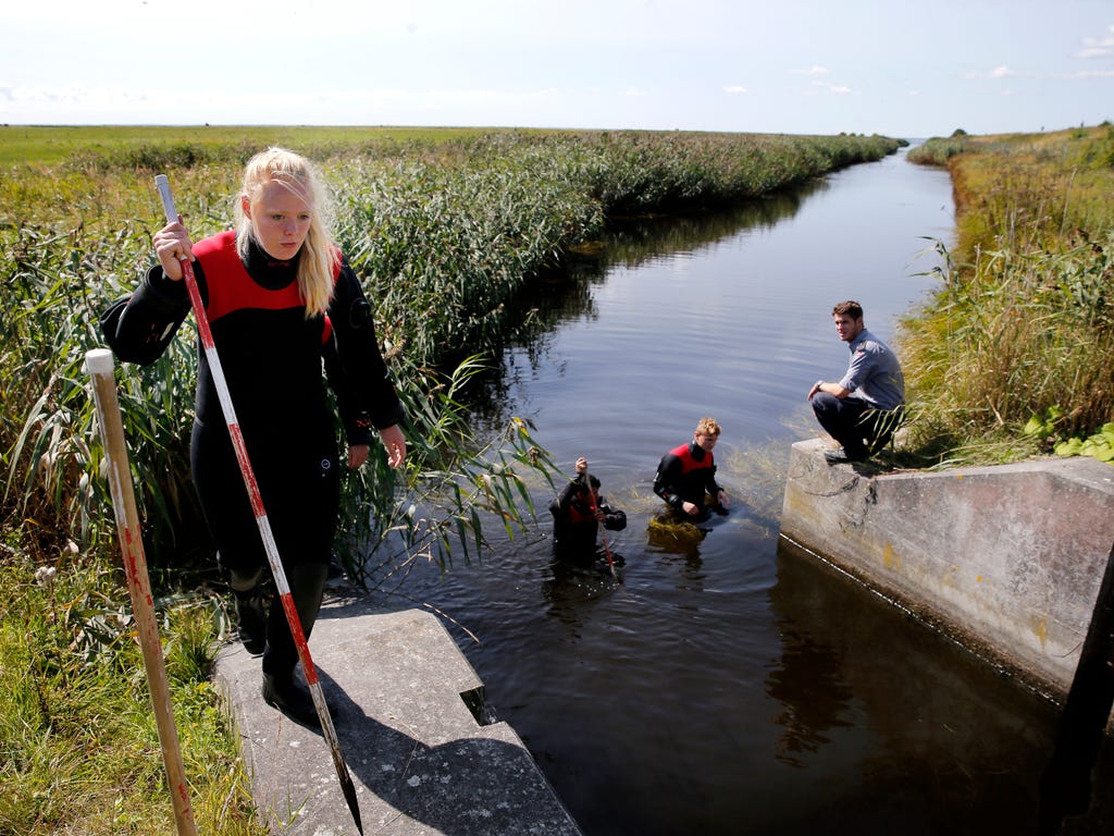 Police and other authorities search a waterway for body remains related to the ongoing Kim Wall murder investigation at the west coast of Amager close to Copenhagen, Denmark on Aug. 23, 2017.  The investigation continues after the headless torso iden