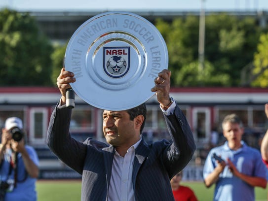 Indy Eleven owner Ersal Ozdemir holds up the 2016 spring