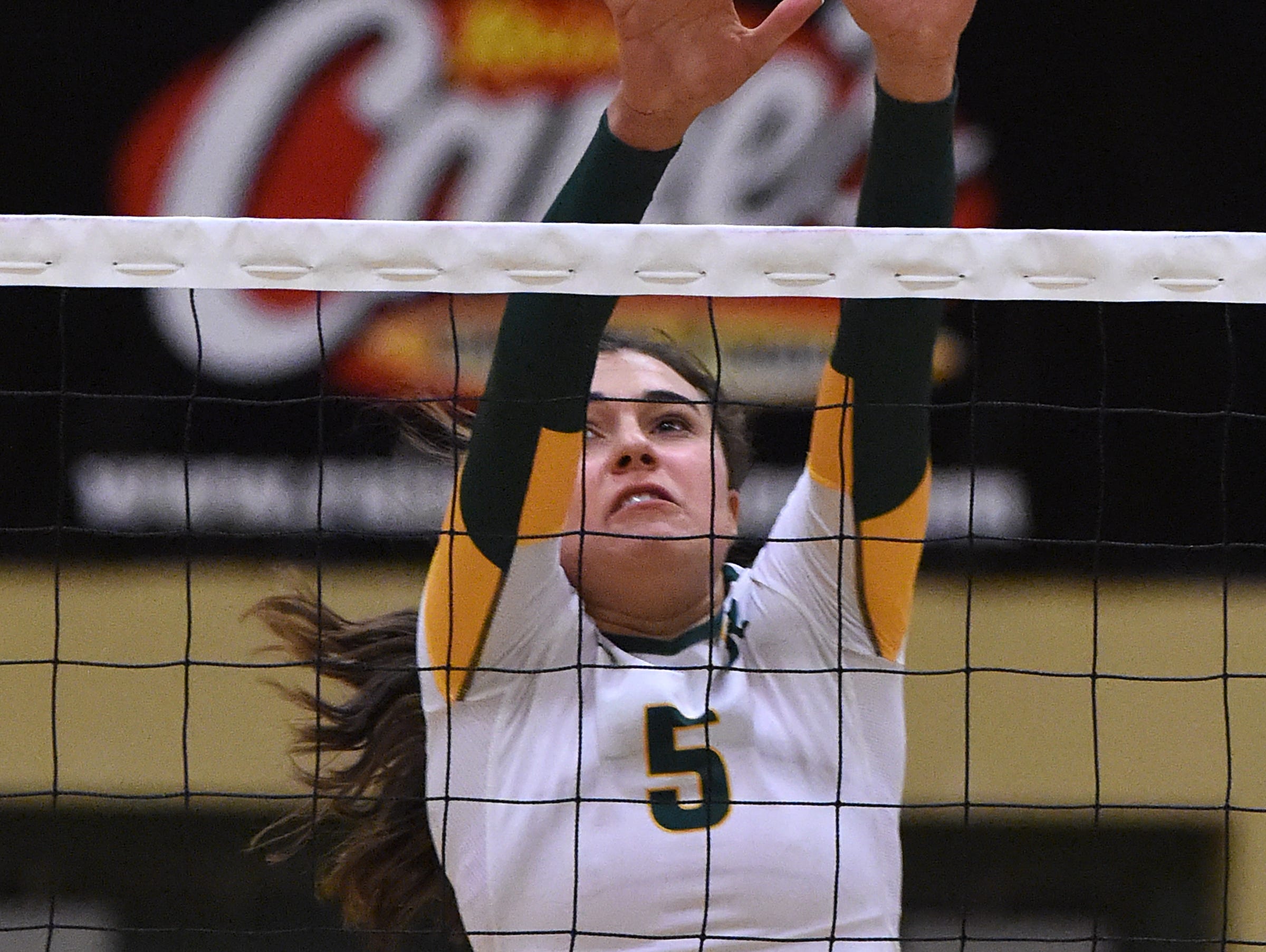 Manogue's Emily Miller goes up for the block against McQueen during Tuesday's game at Manogue High School on Sept. 20, 2016.