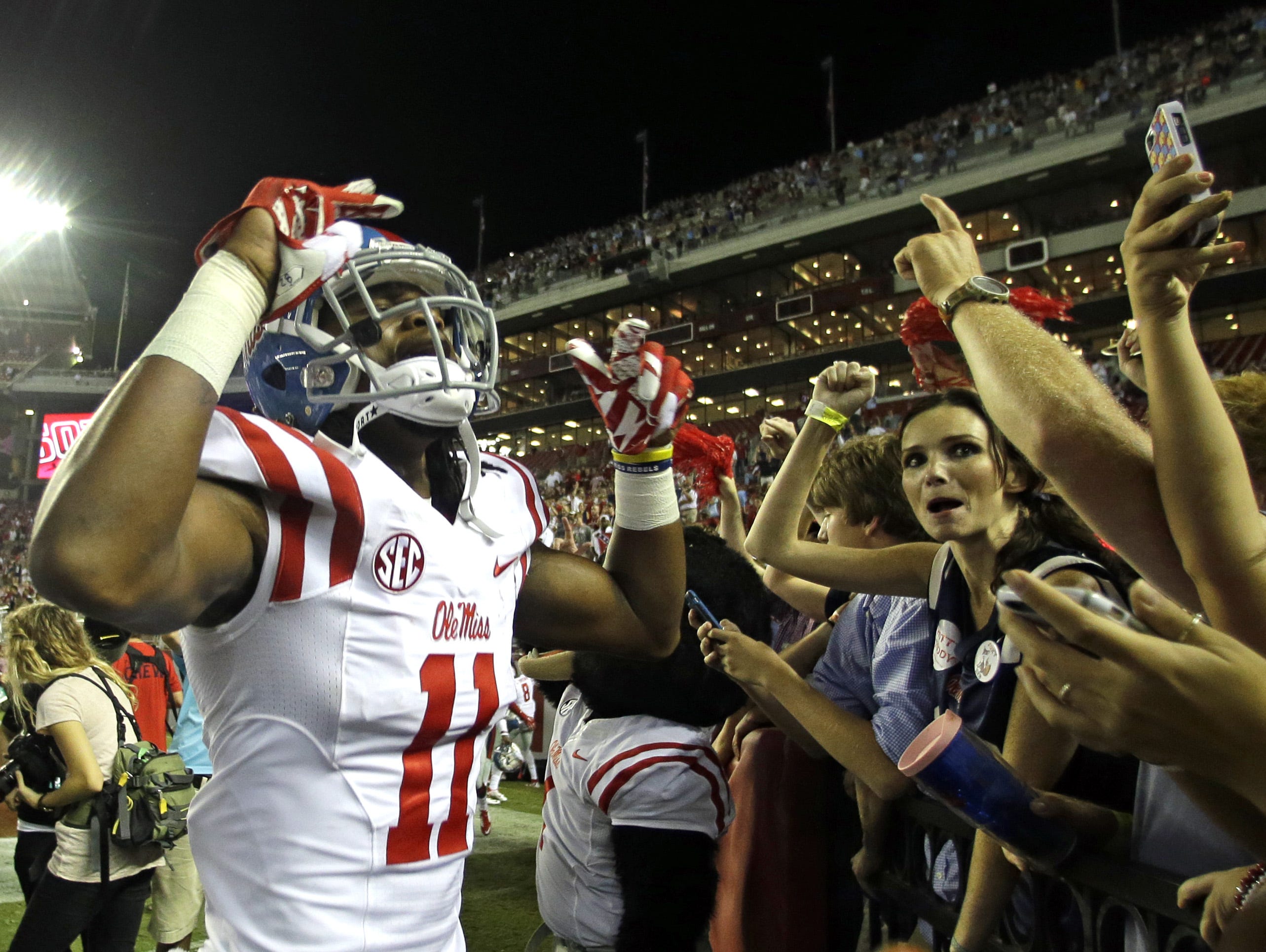 Ole Miss receiver Markell Pack celebrates with a group of fans Saturday night after the Rebels defeated Alabama 43-37 in Tuscaloosa. Mississippi wide receiver Markell Pack (11) celebrates with fans after they defeated Alabama 43-37 during the second half of an NCAA college football game, Sunday, Sept. 20, 2015, in Tuscaloosa, Ala. (AP Photo/Butch Dill)