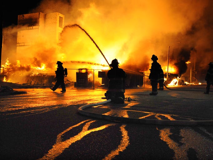 Baltimore firefighters battle a three-alarm fire at