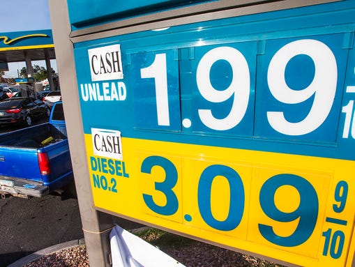 A couple dozen vehicles line up for $1.99 regular unleaded