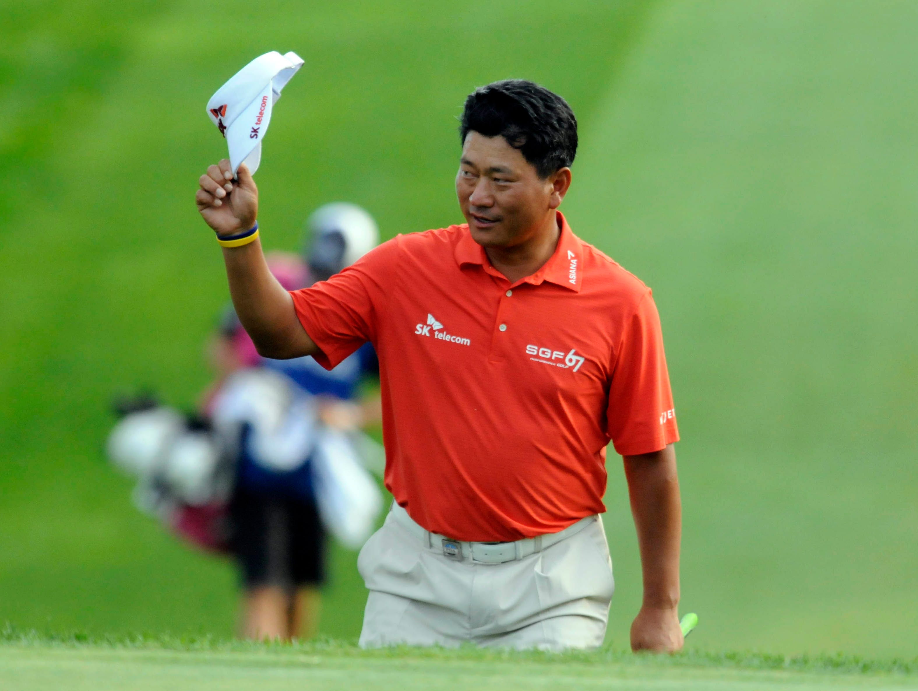 K.J. Choi tips his cap as he walks to the green on the 18th hole.