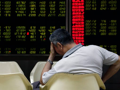 An investor reacts while monitoring stock data on an