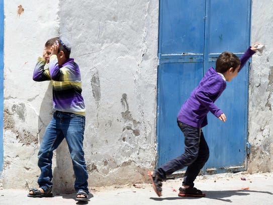 Tunisian Jewish youths play in the streets of Hara