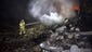 A firefighter puts out fires in the wreckage of Malaysian Airlines flight MH17 that crashed near the town of Shaktarsk, in rebel-held east Ukraine.